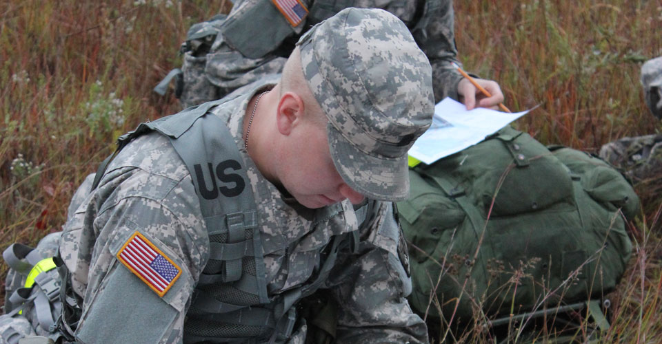 Cadet Kurtis Larson plots his points during the Land Navigation event at the ROTC Joint Field Training Exercise