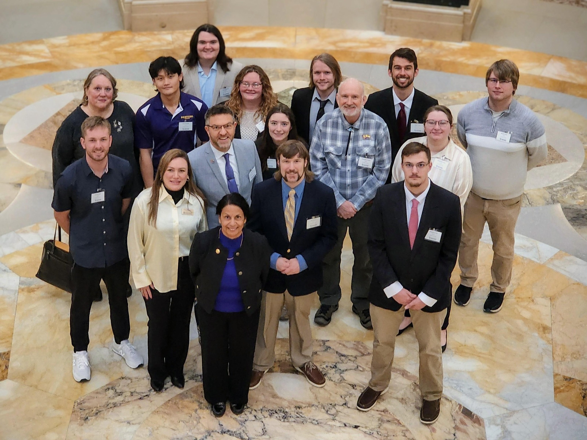 Group of students and faculty standing in the center of the Capitol for Research in the Rotunda.