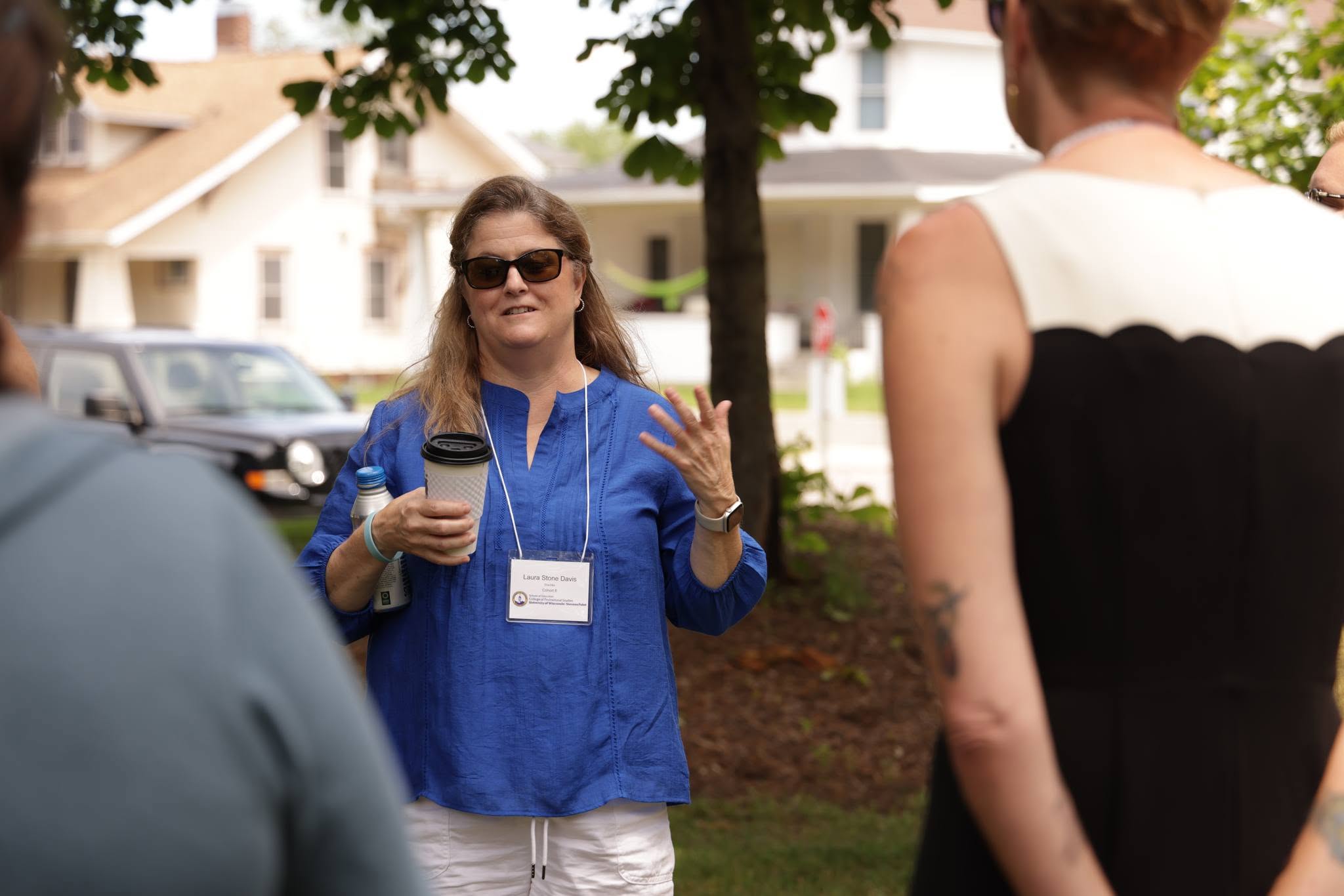 Ed.D. student speaking in small group outside at residency in Stevens Point