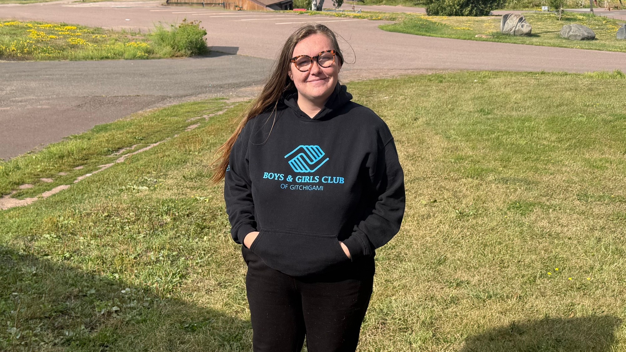 Student standing outside with a Boys & Girls Club sweatshirt on.