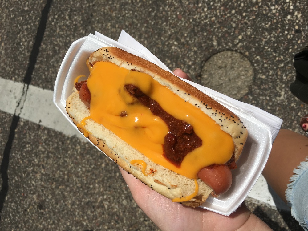 UW-Stevens Point blogger Chloe Wiersma with a chili dog at farmers market