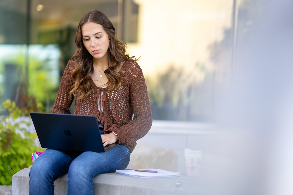Student outside with laptop